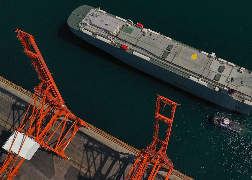 A roll-on roll-off vessel alongside a berth with its stern ramp lowered